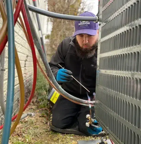Mission Comfort tech working on HVAC unit