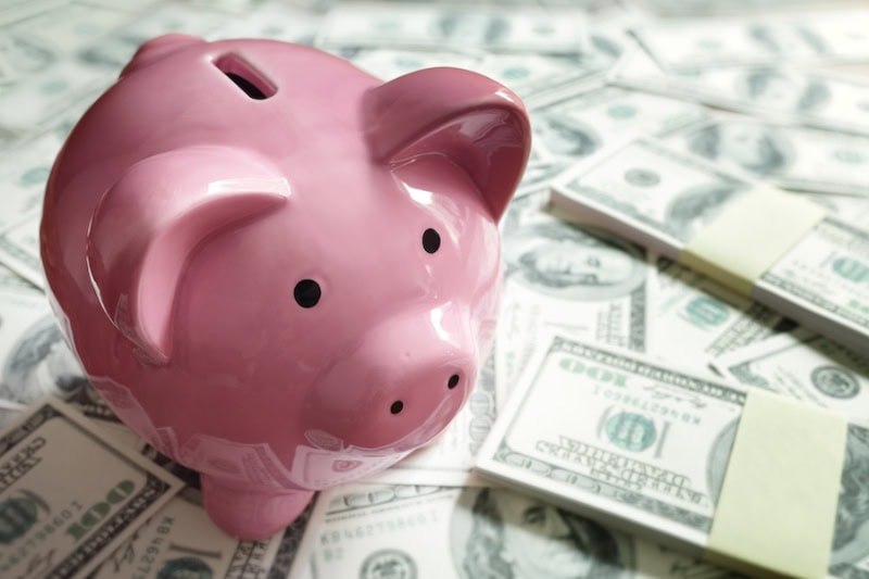 How Tariffs and Refrigerant Changes Are Affecting HVAC Costs. Piggy bank on money concept for business finance, investment, saving or retirement fund.