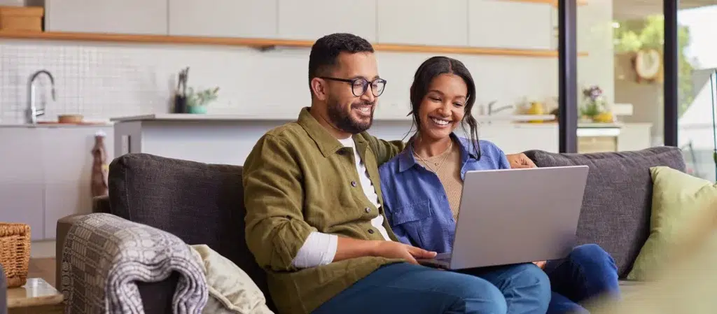 Couple looking at financing options on computer